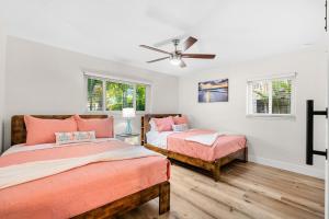 a bedroom with two beds and a ceiling fan at 121 Atlantic Blvd in Indian Harbour Beach +40 photos