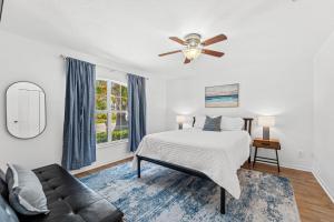 a bedroom with a bed and a ceiling fan at 218 Fifth Avenue in Melbourne Beach +40 photos