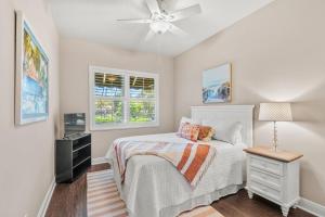 a bedroom with a bed and a ceiling fan at 115 Chipola Rd in Cocoa Beach