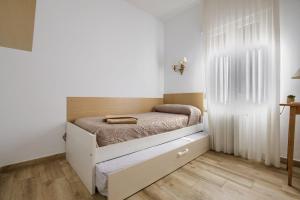 a small bedroom with a bed in the corner at Alojamiento cristo rey in Pozuelo de Alarcón +17 photos