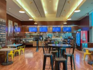 a restaurant with tables and chairs and a bar at Mgm 1 Bedroom Balcony And Or Studio Luxury Suites in Las Vegas