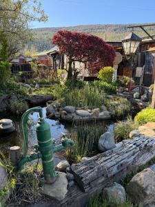 a fire hydrant in the middle of a garden at Tres Coronas in San Martín de los Andes