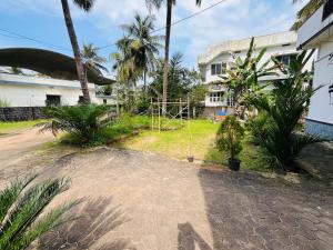 a yard with a playground in front of a building at Coastal Nest Home - Malpe Beach in Malpe