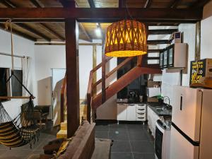 a living room with a couch and a refrigerator at Chalé Foroni in Cunha