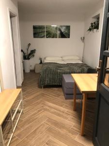 a bedroom with a bed and a table in it at Gemütliches Studio Ohlendorf in Seevetal