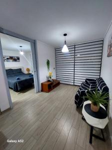a bedroom with a bed and a couch and a table at Sensacional Departamento Centro - Mar 1D 1B in Antofagasta +25 photos
