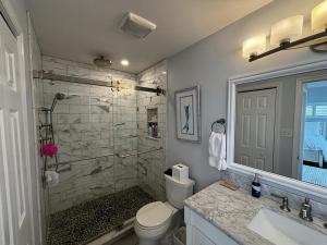 a bathroom with a shower and a toilet and a sink at Wifi Decks Private Yard Beach Badges Beach Chairs Keurig Os Wd 3Rd Off The Beach in Brant Beach +26 photos