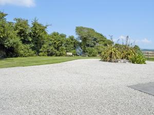 a gravel driveway with a park in the background at The Paddock in Saint Hilary