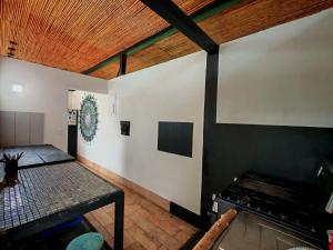 a kitchen with a table and a stove in a room at Pyramid Rocca in Tamarindo
