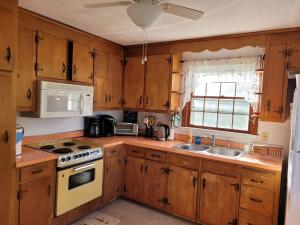 a kitchen with wooden cabinets and a stove top oven at East Granby with AC and WiFi 3 minute to Bradley in East Granby