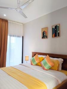 a bedroom with a large bed with colorful pillows at Peaceful Private 4 BR YY Bali Villa, Jimbaran Nusa Dua, In Central Kuta in Jimbaran