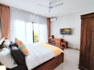 a bedroom with a large bed and a window at Peaceful Private 4 BR YY Bali Villa, Jimbaran Nusa Dua, In Central Kuta in Jimbaran