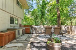 un patio con sillas, una mesa y un árbol en Relaxing River Retreat Near Moms Beach with Patio, en Hacienda