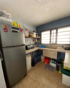 a kitchen with a refrigerator and some shelves at Casita Azul del mar, sencilla con fresca brisa in Chelem +8 photos