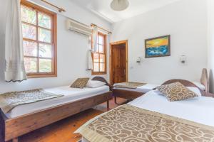 a room with two beds and a window at Mavi & Ani Pansiyon in Antalya +34 photos