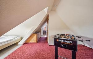 a attic room with a foosball table in the middle at Ferienwohnung Neuhermsdorf in Neuhermsdorf