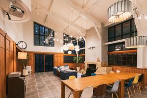 a large room with a wooden table and chairs at Fujisan Lodge En in Fujikawaguchiko