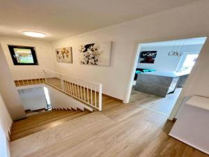 a room with a staircase and a living room at Two-Bedroom Apartment With Terrace in Sreser