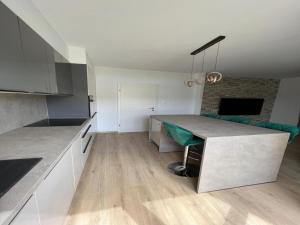 a kitchen with a table and a couch in a room at Two-Bedroom Apartment With Terrace in Sreser +10 photos