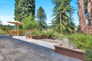 a patio with a table and an umbrella at Stylish 3BR Retreat Close to Coast & Wineries in Occidental