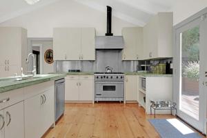a kitchen with white cabinets and a stove at Stylish 3BR Retreat Close to Coast & Wineries in Occidental