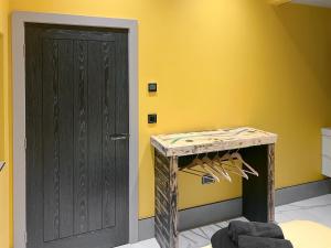 a room with a black door and a yellow wall at Peartree Cottage in Sheffield +14 photos