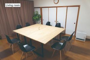 a conference room with a wooden table and chairs at f life house - Vacation STAY 18973 in Koriyama