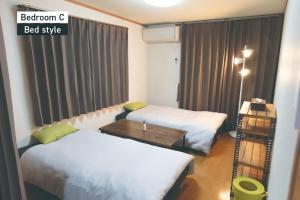 a room with two beds and a table and a window at f life house - Vacation STAY 18973 in Koriyama +58 photos
