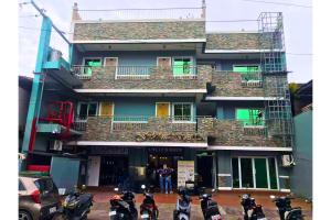 a group of motorcycles parked in front of a building at Filipinas Hostel in Dipolog