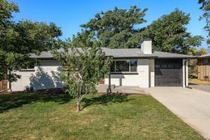 a white house with a tree in the yard at Sleeps 16 Hot Tub Arcade Movie Theater Pool Table in Westminster