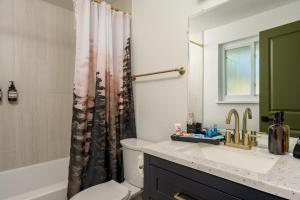 a bathroom with a sink and a shower curtain at Sleeps 16 Hot Tub Arcade Movie Theater Pool Table in Westminster +82 photos