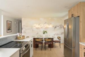 a kitchen with a refrigerator and a table with chairs at Sleeps 16 Hot Tub Arcade Movie Theater Pool Table in Westminster