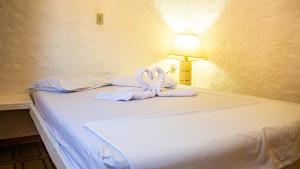 a bed with two swans made out of towels at Parque Pousada Macaquinho Turismo in Serra Negra +82 photos
