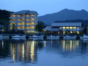a building with boats in the water at night at 萩八景 雁嶋別荘 in Hagi +30 photos