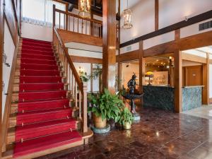 a staircase in a building with a red carpet at 萩八景 雁嶋別荘 in Hagi