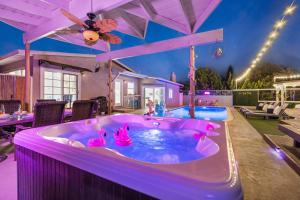 a hot tub in a backyard with pink flamingos in it at Relax and Play-Pool, Spa, Views plus Guest House! in La Mesa