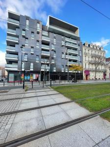 a large building on a street in front of a building at Balcon sur docks - 4 lits - 4 beds in Le Havre +3 photos