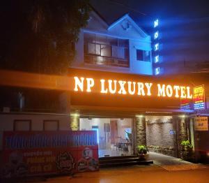 a npr luxury motel lit up at night at NP Luxury Motel in Ấp Hưng Lộc