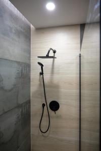a shower with a shower head in a bathroom at Empire Home! in Praia +45 photos