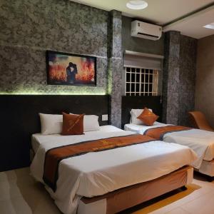 Ένα ή περισσότερα κρεβάτια σε δωμάτιο στο NP Luxury Motel