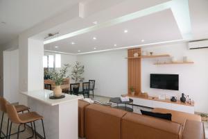 a living room with a couch and a table at Empire Home! in Praia