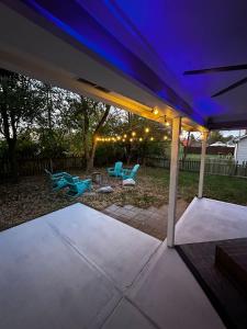 a pergola with blue lights on a patio at Hidden Gem Hot tub pool table - EV charger Sleep number Bed in Perry Manor