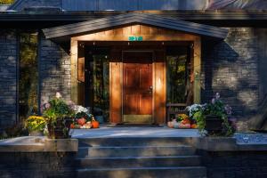 a front door of a house with pumpkins on the steps at Rent An Inn! Takeover the Birch Ridge with your group, Mountain Lodge- 11 Rooms, Bar, Fireplace, 28ppl home in Killington