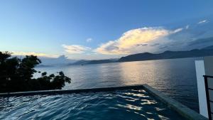a swimming pool with a view of the water at Refúgio da Lagoa azul in Angra dos Reis +30 photos