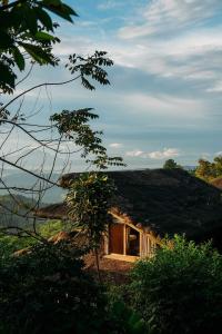 a small house with a thatched roof at Narra Hill Tagaytay in Laurel +4 photos