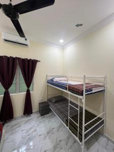 two bunk beds in a room with a ceiling at Adam Hawa Homestay Bachok in Bachok