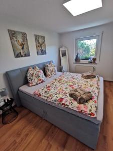 a bedroom with a bed with a floral comforter at Chalet Bambi in Blaibach