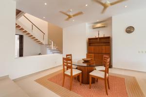 a dining room with a table and chairs at Exclusive Villa with private pool, Jungle and Golf views - 8 Min Walk to the Beach in Puerto Aventuras +26 photos