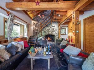 a living room with leather couches and a stone fireplace at Chalet à Méribel avec service de conciergerie et animaux admis - FR-1-613-143 in Méribel