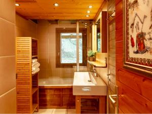 a bathroom with a sink and a tub and a window at Chalet à Méribel avec service de conciergerie et animaux admis - FR-1-613-143 in Méribel +11 photos